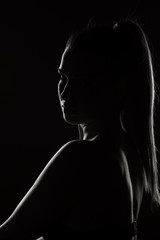 Fototapeta na wymiar silhouette of a woman on a dark background