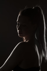 silhouette of a woman on a dark background