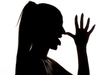 silhouette profile of a woman who is mocking with the palm of on the nose - obrazy, fototapety, plakaty