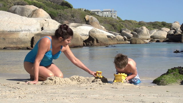 Mother and child playing on beach with toys,Boulders Beach,Cape Town,South Africa