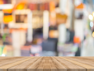 Wooden board empty table blurred background. Perspective brown wood over blur in department store - can be used for display or montage your products.Mock up for display of product.