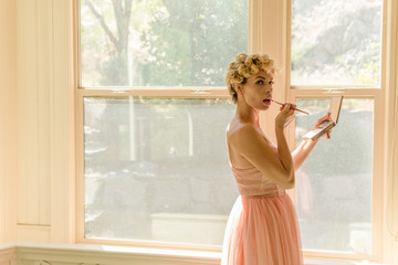 Beautiful young woman apply makeup