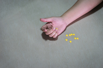 Close-up on the floor of the drugs in hand. a young drug addict