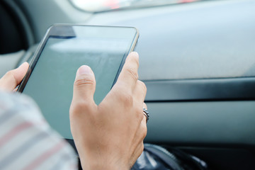 communication technology background,image of using a digital tablet inside of a car. 