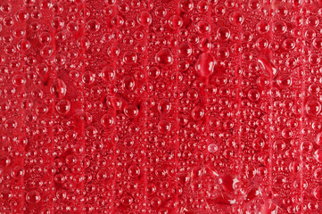 Water drops on red glass