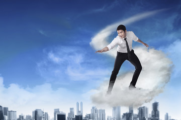 Asian business person flying with the cloud