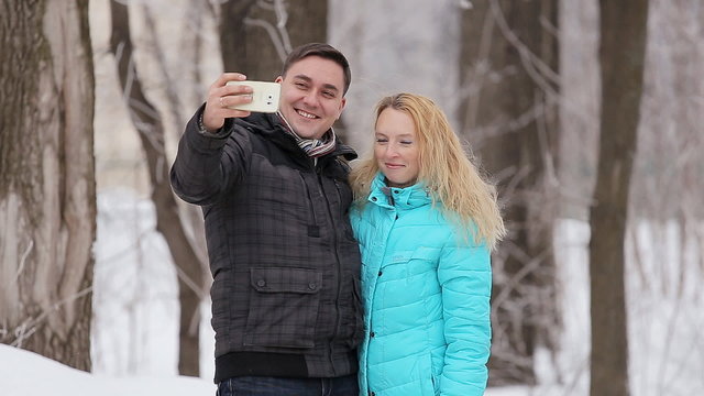 Happy couple taking selfie, winter day