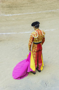 torero with red and gold costume waiting for the bull