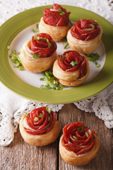 Baked rolls with salami in the form of roses closeup. vertical
