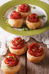 Baked rolls with salami in the form of roses. vertical
