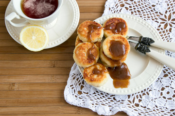 curd fritter with caramel and tea