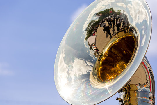 big brass tuba with reflections against blue sky