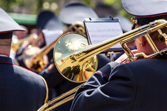 musician of the military orchestra playing on gold trombone