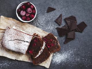 Chocolate cake on baking paper with ingredients