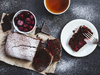 Chocolate cake on baking paper with ingredients