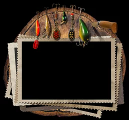 Fototapeten Fishing Tackle and Empty Photo Frames / Empty, old and vintage photo frames and artificial fishing baits with folding knife. On a tree trunk and Isolated on a black background © Alberto Masnovo