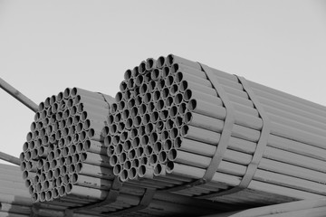 Many steel pipes stacked together