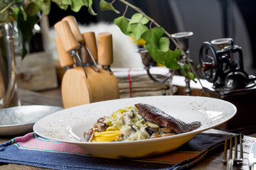 Tasty spagetti with honey fungus and shiitake mushrooms on an old wooden table