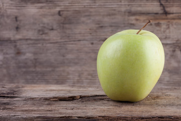 fresh green apple on grunge old wooden background