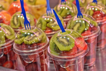 Fruit salad in plastic glasses in outdoors cafe - 103236017