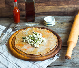cook rye biscuit with goat cheese and herbs, wooden board