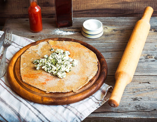 cook rye biscuit with goat cheese and herbs, wooden board