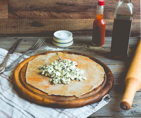 cook rye biscuit with goat cheese and herbs, wooden board,tone