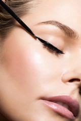 Close-up make-up with black eyeliner - obrazy, fototapety, plakaty