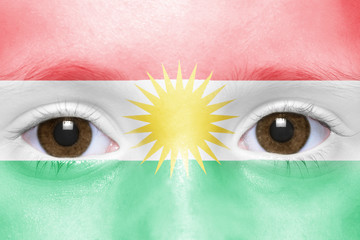 human's face with kurdish flag