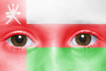 human's face with omani flag