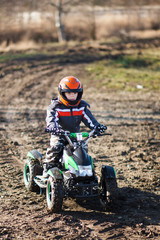 Boy rides on electric ATV quad.