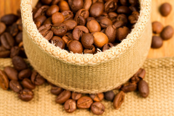 Coffee beans in fabric on a wooden