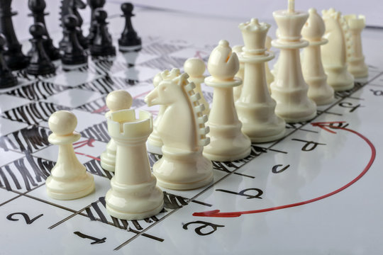 Chess. White board with chess figures on it. Plan of battle.
