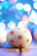 White Easter egg with red pattern on lighting background
