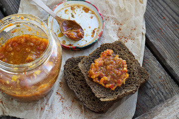 Traditional sauce adjika with bread, selective focus