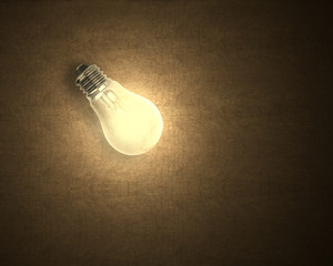 Single light bulb on wooden surface