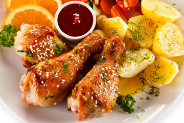 Grilled chicken legs with boiled potatoes and vegetables