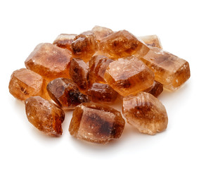 Brown caramelized lump cane sugar cube isolated on white backgro