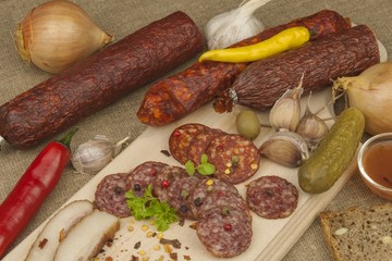 
Spicy sausages on a wooden cutting board. Preparing the menu. Entertainment for visitors. Production of delicious sausages.
