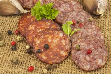 Spicy sausages on a linen background. Preparing the menu. Entertainment for visitors. Production of delicious sausages.

