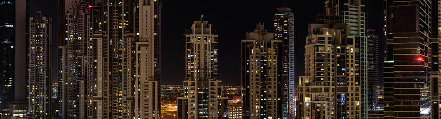 Fototapeta na wymiar Panorama of new residential buildings in Dubai at night.
