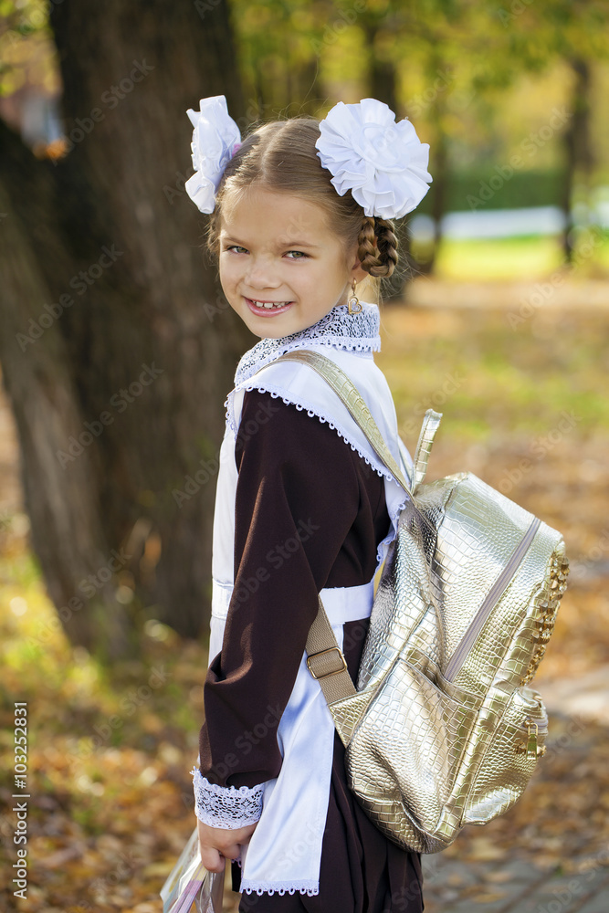 Poster Portrait of a beautiful young first-grader in a festive school u