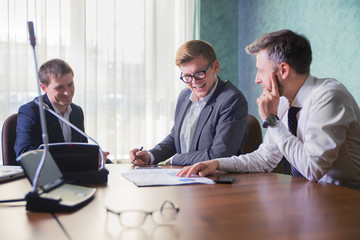 businesspeople or business man and client working at office