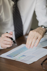 closeup of hands with financial charts at business meeting in the office