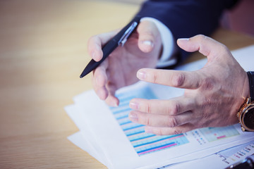 
businessman hands in an emotional gesture in a close shot on the background of business documents and graphics