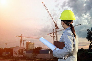 portrait women asia engineer working and holding blueprints at c