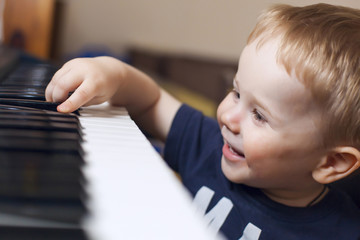 Small boy enjoys playing electric piano