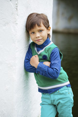 Fashionable little boy outdoor at the nice summer day