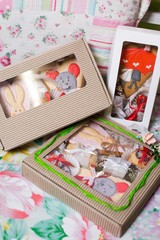 a collection of gingerbread cookies in the shape of a heart, muffins and animals on a white wooden background