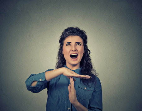 woman showing time out hand gesture, frustrated screaming to stop